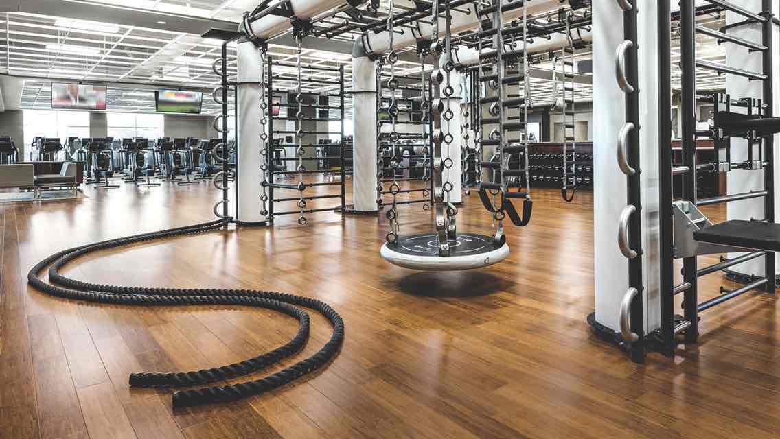 A spacious fitness floor featuring a large functional training structure